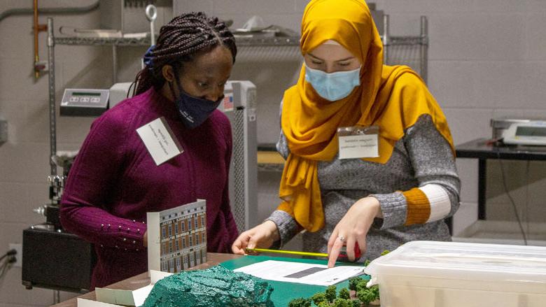 Two female engineering students work on a project as part of the 2021 Women in Engineering competition